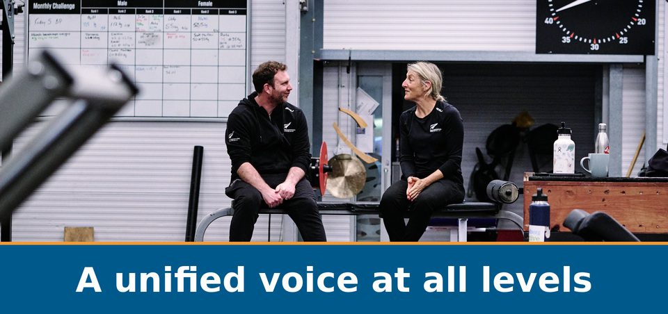 Two coaches discussing their work in a training gym: A unified voice at all levels.